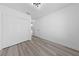 Neutral bedroom featuring wood-look floors, a modern light, and a closet at 2208 Spring Water Dr, Las Vegas, NV 89134