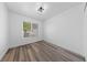 Bright bedroom with stylish wood-look floors and a modern ceiling light fixture at 2208 Spring Water Dr, Las Vegas, NV 89134