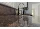 Close up on kitchen granite countertop with stainless steel sink and modern black faucet at 2208 Spring Water Dr, Las Vegas, NV 89134
