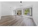 Bright and airy living room with wood-look flooring and a sliding glass door at 2208 Spring Water Dr, Las Vegas, NV 89134