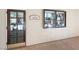 Exterior shot of the Sewing room; view through the glass paneled door of its interior and display window on wall at 2208 Spring Water Dr, Las Vegas, NV 89134