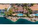 Aerial view of the home featuring a pool, lake access, palm trees, and red tile roof at 2209 Glenbrook Way, Las Vegas, NV 89117