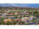 Aerial view of the property showcasing the community, surrounding greenery, lake, and mountain views in the distance at 2209 Glenbrook Way, Las Vegas, NV 89117