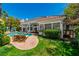 Expansive backyard with a sparkling pool, sun loungers, and lush landscaping, perfect for outdoor relaxation and entertainment at 2209 Glenbrook Way, Las Vegas, NV 89117