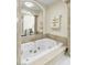 Bright bathroom showcasing a luxurious soaking tub with gold fixtures and marble accents at 2209 Glenbrook Way, Las Vegas, NV 89117