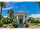 Grand clubhouse entrance with elegant columns, landscaped grounds, and a welcoming facade at 2209 Glenbrook Way, Las Vegas, NV 89117