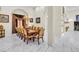 Elegant dining room with a long table set for twelve, chandelier, and large windows with custom drapery at 2209 Glenbrook Way, Las Vegas, NV 89117