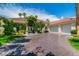 Charming home featuring a well-manicured lawn, mature trees, and a spacious driveway leading to a three-car garage at 2209 Glenbrook Way, Las Vegas, NV 89117