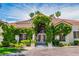 Charming single-story home featuring a tile roof, lush landscaping, and a welcoming double-door entrance at 2209 Glenbrook Way, Las Vegas, NV 89117