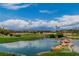 Beautiful view of a golf course with a tranquil pond, palm trees, and mountain backdrop at 2209 Glenbrook Way, Las Vegas, NV 89117