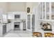 Modern kitchen featuring stainless steel appliances, white cabinetry, marble countertops, and ample counter space at 2209 Glenbrook Way, Las Vegas, NV 89117