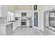 Modern kitchen with stainless steel appliances, white cabinets, and marble countertops and flooring at 2209 Glenbrook Way, Las Vegas, NV 89117