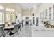 Bright kitchen with white cabinets, marble countertops, stainless steel appliances, and an adjacent breakfast area at 2209 Glenbrook Way, Las Vegas, NV 89117