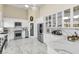 Bright and airy kitchen featuring modern white cabinets, stainless steel appliances, and marble countertops at 2209 Glenbrook Way, Las Vegas, NV 89117