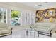 Bright living room with white sofas, large windows with shutters, and decorative wallpaper at 2209 Glenbrook Way, Las Vegas, NV 89117