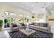 Bright living room features high ceilings, large windows, and stylish furniture with easy access to the outdoors at 2209 Glenbrook Way, Las Vegas, NV 89117