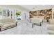 Elegant living room with marble floors, white sofas, decorative wallpaper, and bright natural light at 2209 Glenbrook Way, Las Vegas, NV 89117