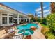 A backyard oasis featuring a pool, spa, patio and lush landscaping, creating a perfect outdoor retreat at 2209 Glenbrook Way, Las Vegas, NV 89117