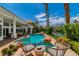 Outdoor patio with comfortable seating overlooking the sparkling pool and spa surrounded by a well-manicured backyard at 2209 Glenbrook Way, Las Vegas, NV 89117
