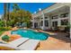 Inviting backyard with a pristine pool, waterfall feature, and comfortable lounge chairs for enjoying sunny days in style at 2209 Glenbrook Way, Las Vegas, NV 89117