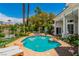 Beautiful backyard pool featuring rock accents, lush landscaping, and a relaxing waterfall feature for ultimate outdoor enjoyment at 2209 Glenbrook Way, Las Vegas, NV 89117