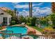 Enjoy a relaxing backyard pool with stone accents, tropical landscaping, and views of the clear blue water and the surrounding community at 2209 Glenbrook Way, Las Vegas, NV 89117