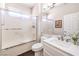 Clean bathroom featuring a shower-tub combo with glass doors, toilet, and single sink vanity at 2330 Spring Water Dr, Las Vegas, NV 89134
