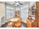 Bright breakfast nook featuring a round table, wood chairs, and natural light from shuttered windows at 2330 Spring Water Dr, Las Vegas, NV 89134
