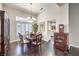 Elegant dining room with wood floors, chandelier, and natural light from shuttered windows at 2330 Spring Water Dr, Las Vegas, NV 89134