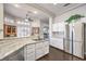 Bright kitchen featuring granite countertops, stainless steel appliances, and white cabinetry at 2330 Spring Water Dr, Las Vegas, NV 89134