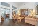Well-lit living room with wood floors and a classic furniture set, including a large wooden display cabinet at 2330 Spring Water Dr, Las Vegas, NV 89134