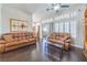 Spacious living room with hardwood floors, comfortable seating, and large windows at 2330 Spring Water Dr, Las Vegas, NV 89134