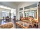 Bright living room with wood floors, traditional furnishings, and a view into dining and sitting areas at 2330 Spring Water Dr, Las Vegas, NV 89134