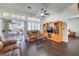 Cozy living room featuring hardwood floors, a ceiling fan, and sliding glass door leading to the outdoors at 2330 Spring Water Dr, Las Vegas, NV 89134