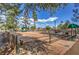 Community shuffleboard court featuring shaded seating area and lush, mature landscaping in a park-like setting at 2330 Spring Water Dr, Las Vegas, NV 89134