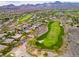 Aerial view showcases a golf course community with beautiful homes and stunning mountain backdrop at 2383 Rainswept Ave, Henderson, NV 89052