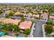 Aerial view of a residential area featuring mature trees, tile roofs, and neatly landscaped properties at 2383 Rainswept Ave, Henderson, NV 89052