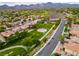 Neighborhood aerial view showcasing green spaces, residential homes, and mountain views at 2383 Rainswept Ave, Henderson, NV 89052