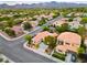 Aerial view of a cozy home nestled in a tranquil neighborhood with mountain views in the distance at 2383 Rainswept Ave, Henderson, NV 89052