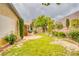 Backyard featuring a lawn, garden, and covered patio with grill at 2383 Rainswept Ave, Henderson, NV 89052