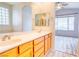 Bathroom boasts double sinks and a view into the bedroom and enclosed toilet at 2383 Rainswept Ave, Henderson, NV 89052