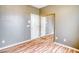 Bedroom with wood floors and mirrored closet doors at 2383 Rainswept Ave, Henderson, NV 89052