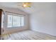 Bright bedroom with wood floors, ceiling fan, and a large window providing ample natural light at 2383 Rainswept Ave, Henderson, NV 89052