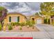 Charming single-story home showcasing desert landscaping and attached two-car garage at 2383 Rainswept Ave, Henderson, NV 89052