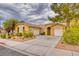 Inviting single-story home with attached two-car garage and well-maintained landscaping at 2383 Rainswept Ave, Henderson, NV 89052