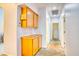 Hallway featuring tile flooring and built-in wood cabinets at 2383 Rainswept Ave, Henderson, NV 89052