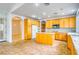 Well-lit kitchen boasts a functional island, stainless steel appliances, and easy access to other rooms at 2383 Rainswept Ave, Henderson, NV 89052