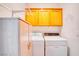 Practical laundry room features washer, dryer, storage cabinets, and shelving at 2383 Rainswept Ave, Henderson, NV 89052