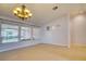 Spacious living room with tile flooring and expansive windows overlooking the backyard at 2383 Rainswept Ave, Henderson, NV 89052