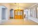 Elegant living room featuring arched doorways, tile flooring and display cabinet at 2383 Rainswept Ave, Henderson, NV 89052